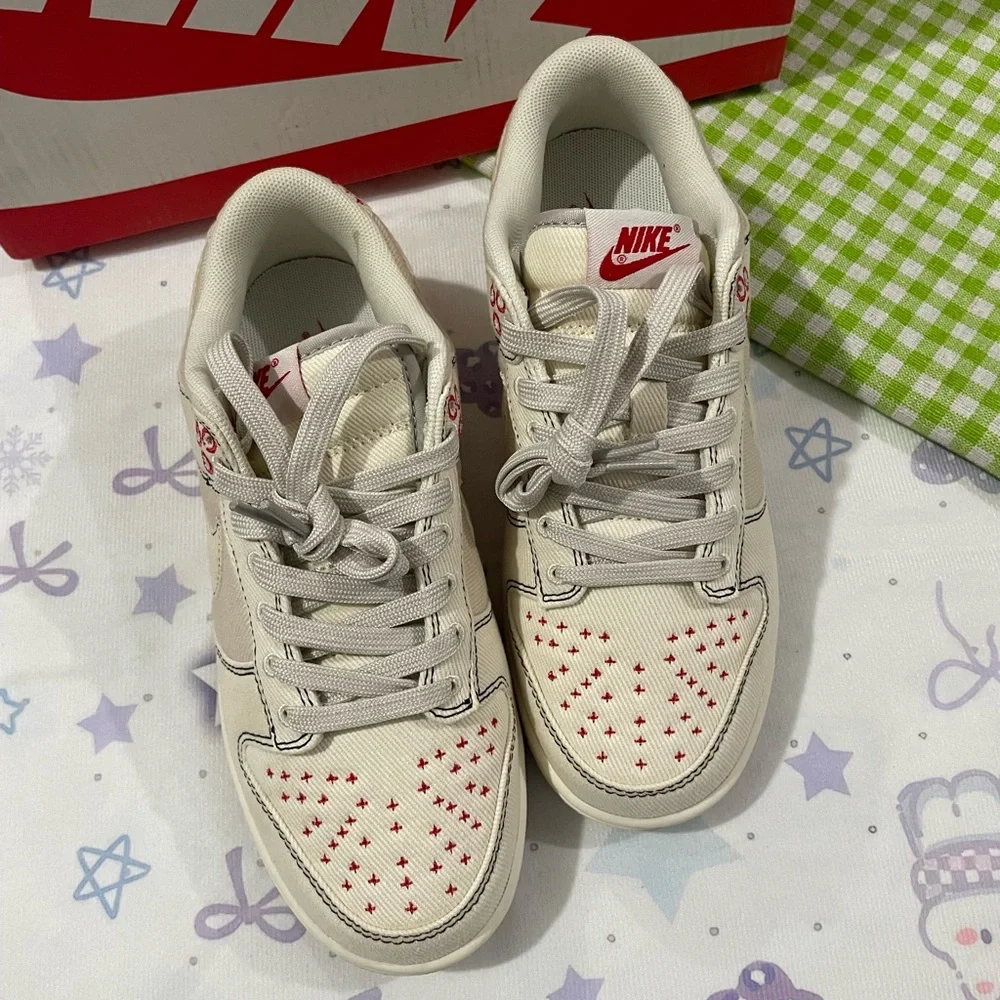 Nike Low-Top Sneakers in Cream with Red Details